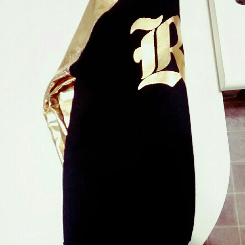 Rolling paper sweater gold leather sleeves.